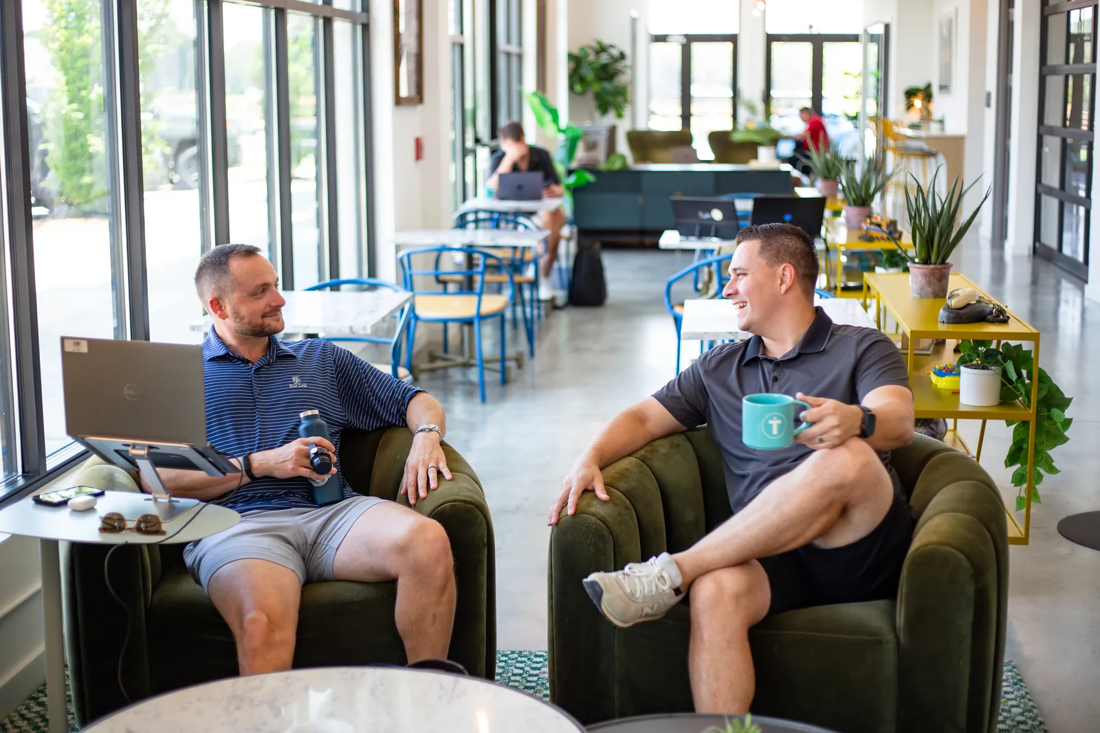 Two members chatting in the lounge at a THRIVE coworking space