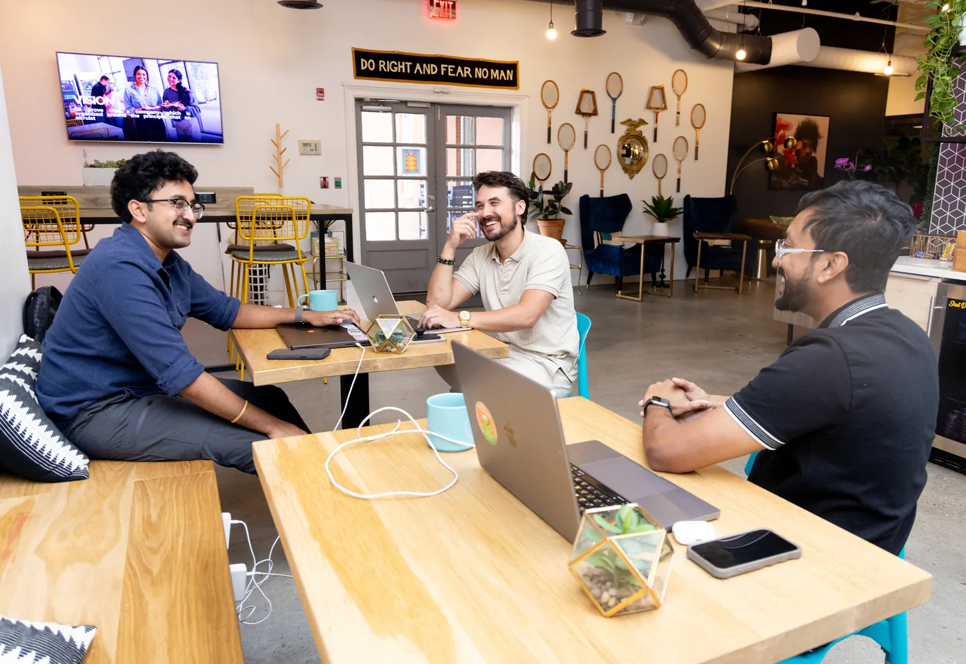 Members working together at a communal table at THRIVE