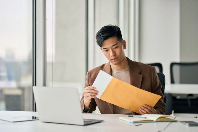 A professional opening mail received at his THRIVE business address